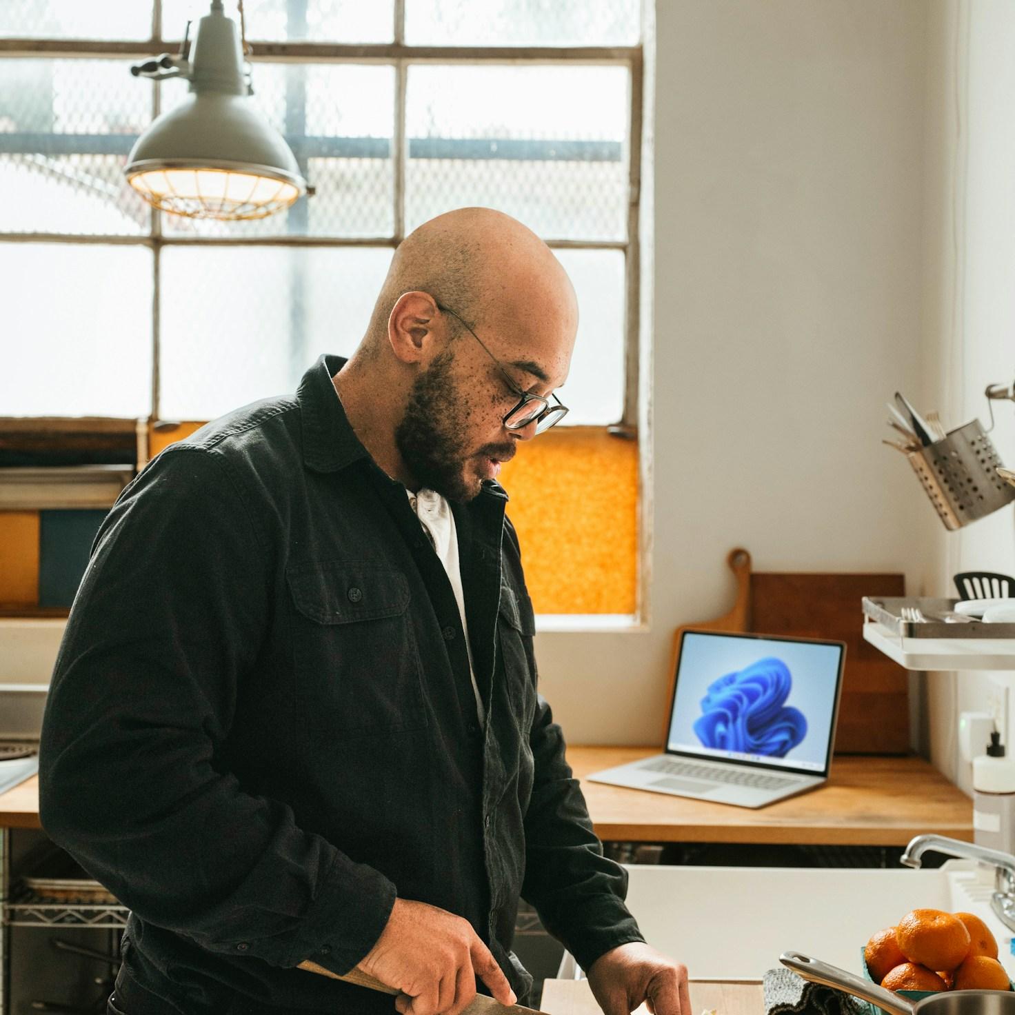 Community members collaborating in a modern kitchen, exchanging recipes and techniques